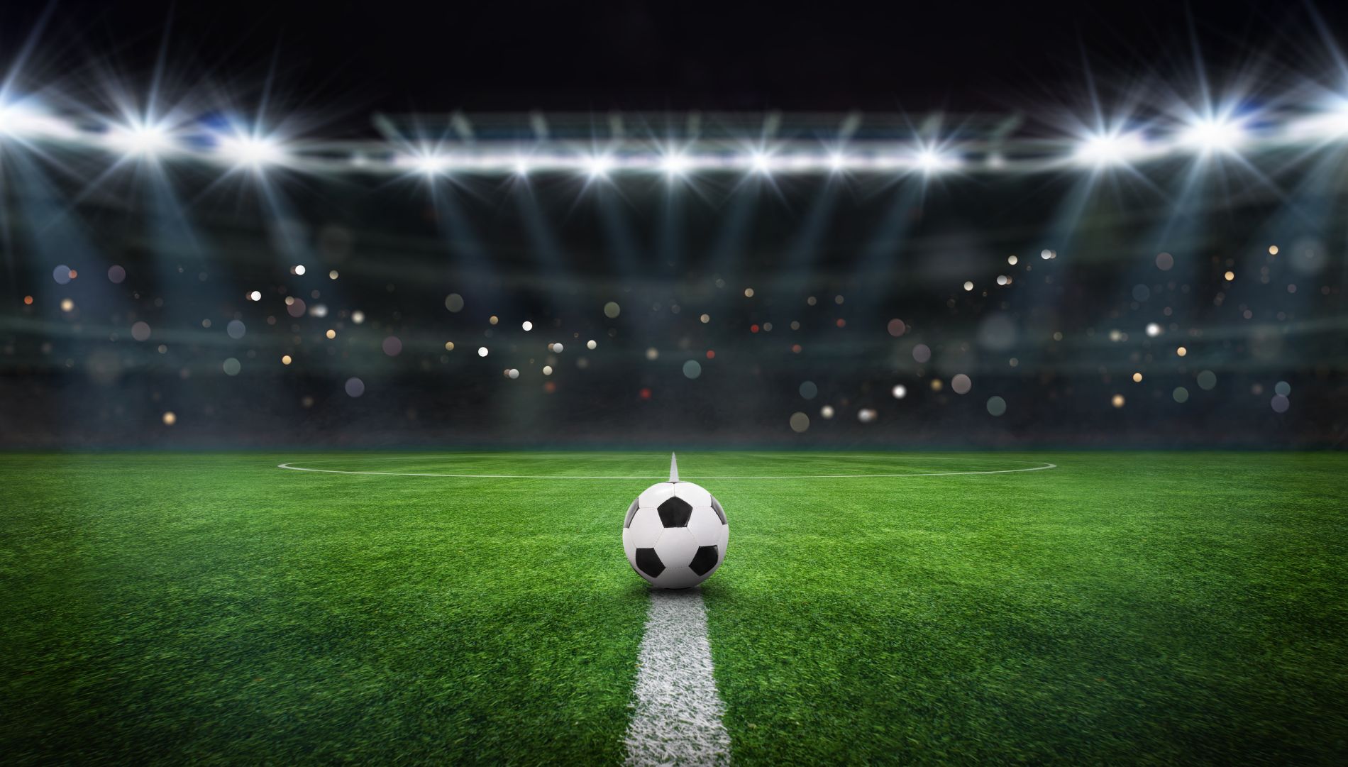 Soccer ball on lit soccer field