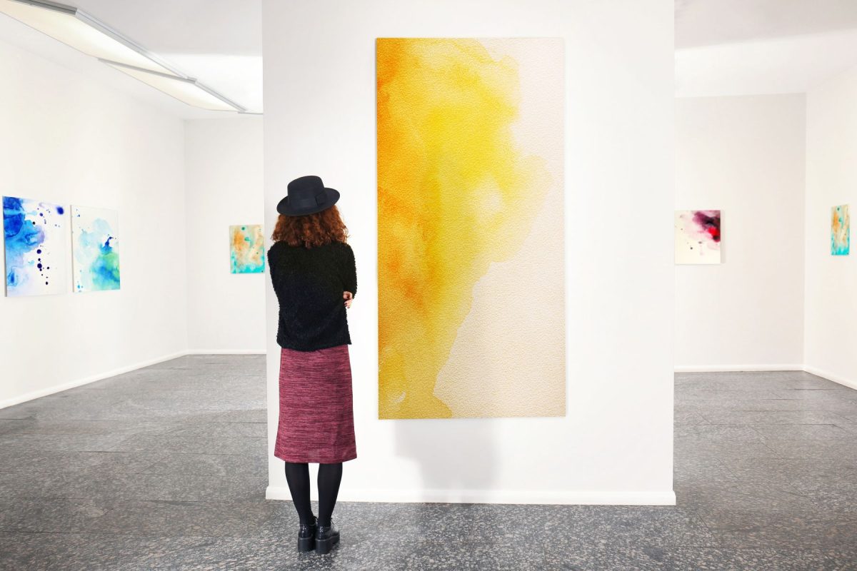 Young woman looking at modern art in gallery