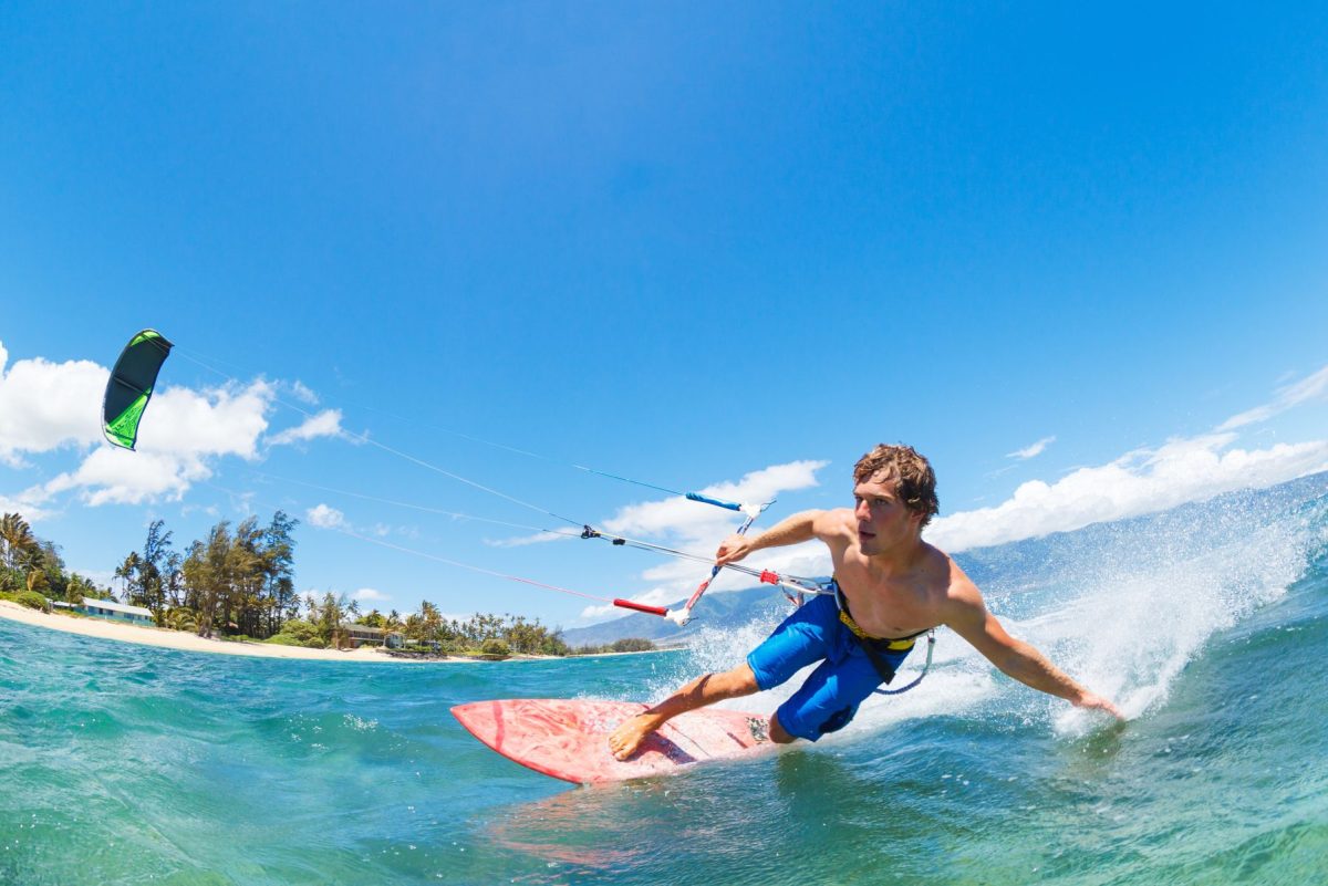 young man kiteboarding